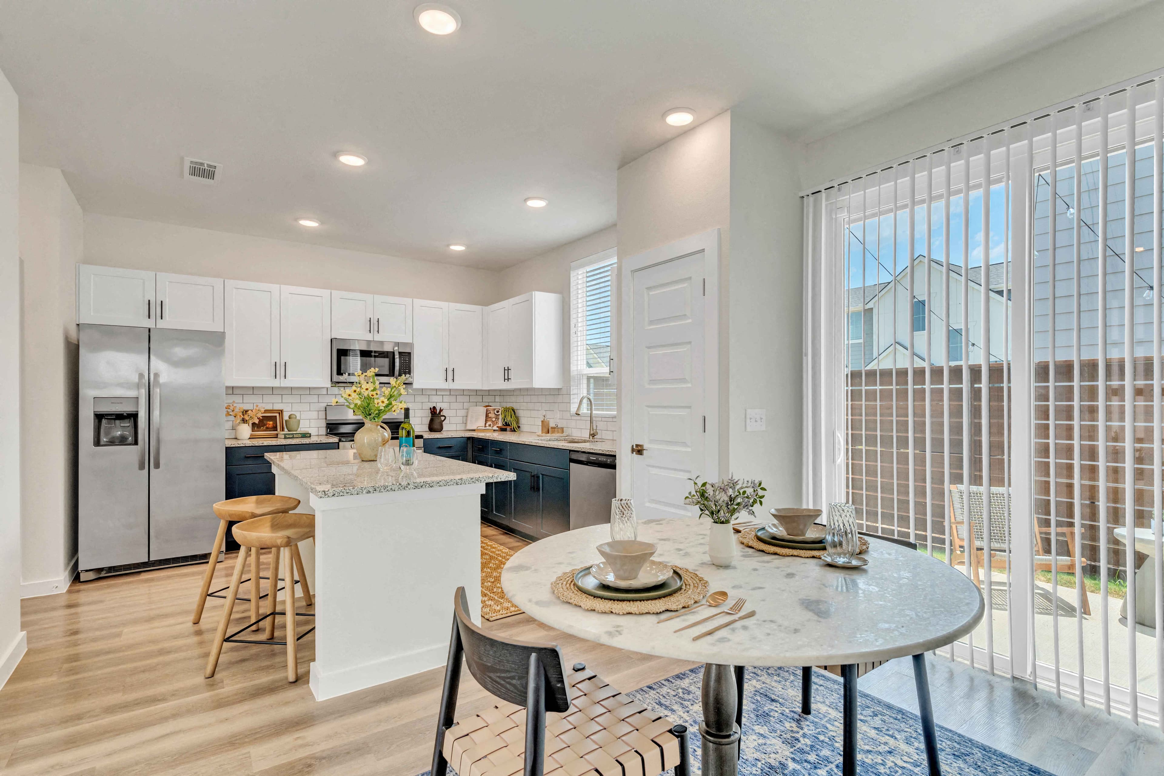 an open kitchen and dining area with a table and chairs